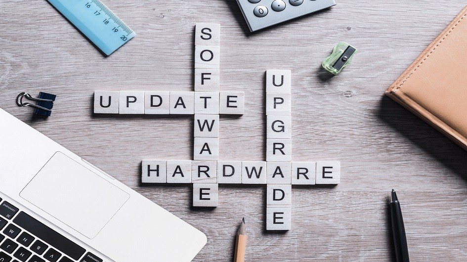Letter tiles on a desk spelling out software update, hardware upgrade