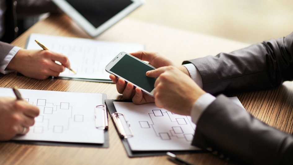 Business professionals in a meeting about mobile capture