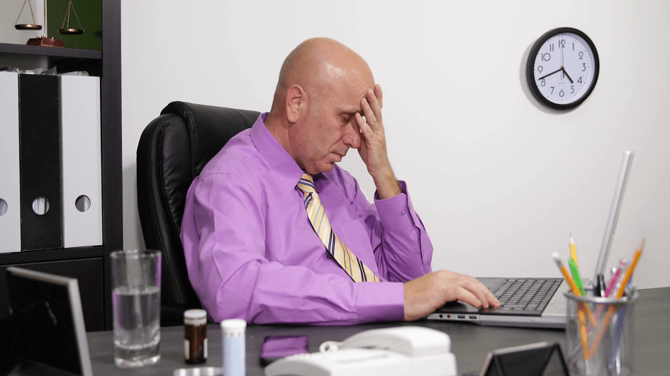 Professional man at his desk in pain