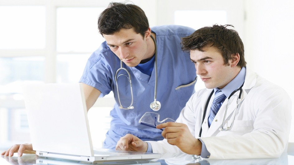 Doctor and nurse looking at computer