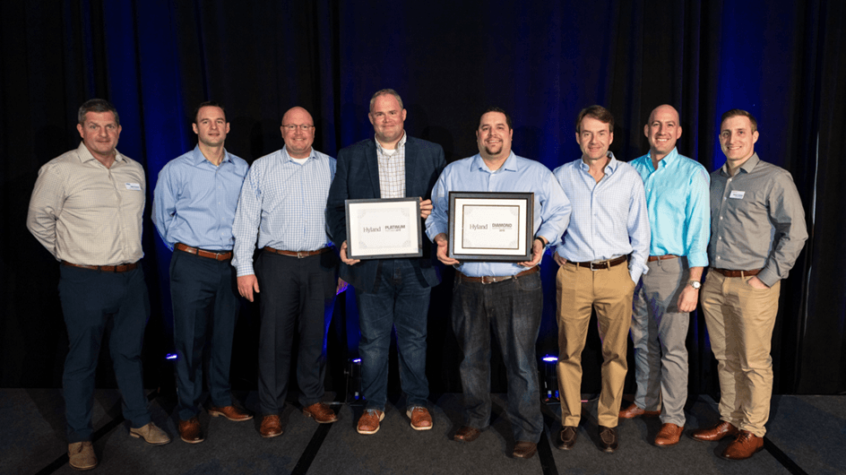 Kiriworks team receiving an award from Hyland Software, Platinum and Diamond honors